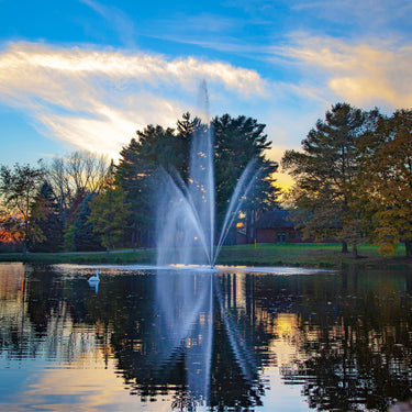 Scott Aerator Atriarch Pond Fountain On The Water With Trees & A House In The Background